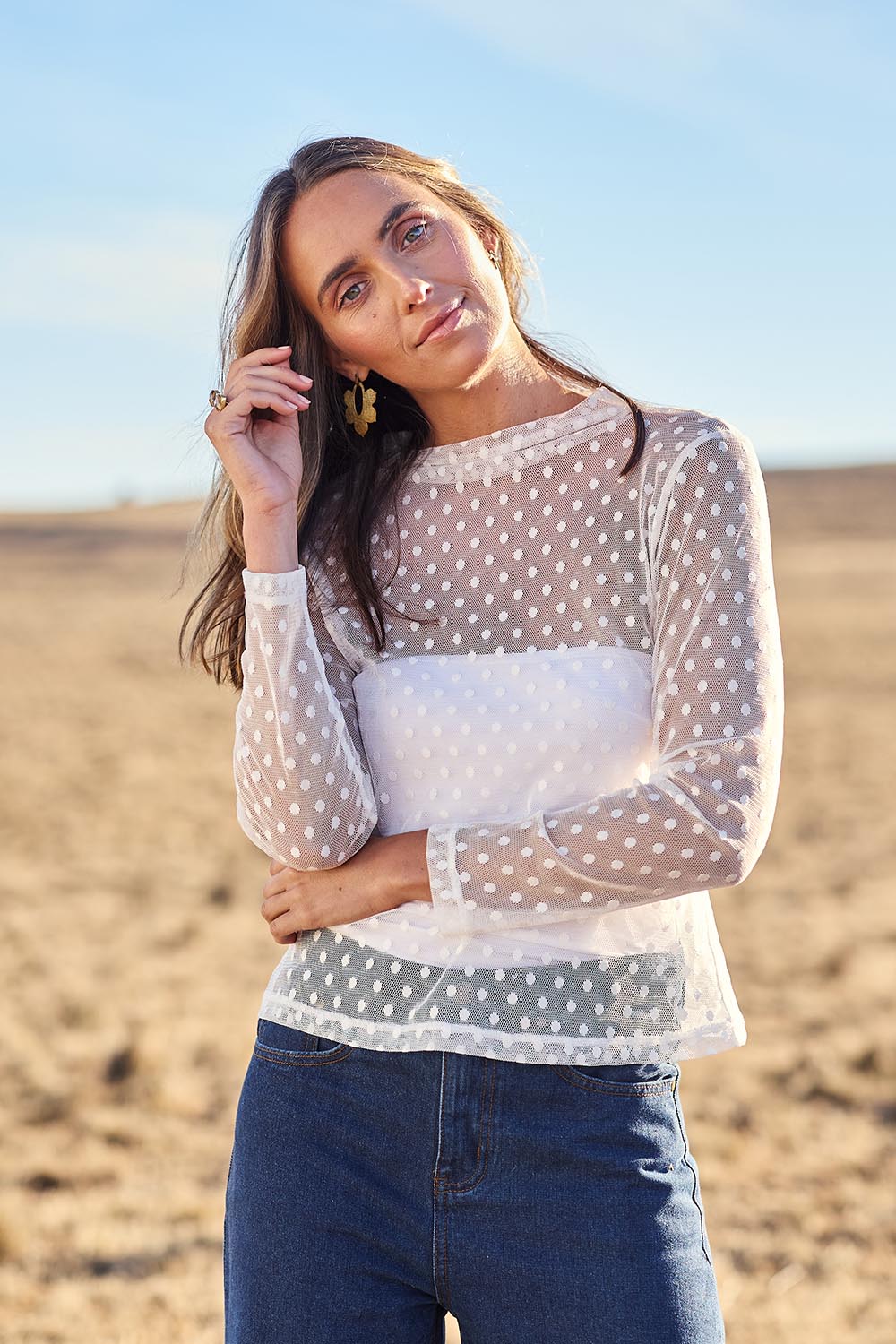 Model Tegan wearing size 10 of the Layer Me Up Lace Mesh Long Sleeve Top in colour White (White), from the front, showing the whole outfit