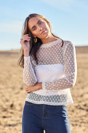 Model Tegan wearing size 10 of the Layer Me Up Lace Mesh Long Sleeve Top in colour White (White), from the front, showing the whole outfit