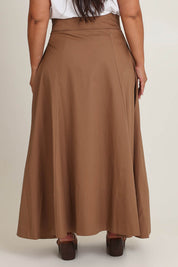Model Ashleigh wearing size 16 of the Timeless Love Cotton Maxi Skirt in colour Dune, from the back