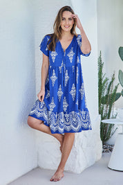 Model Tegand wearing size 10 of the Sunset Happy Hour Dress – Royal in colour Royal, from the front