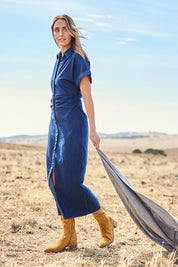 Model Tegan wearing size 10 of the Hold Me Close Denim Maxi Dress in colour Denim (Blue), from the front, showing the whole outfit