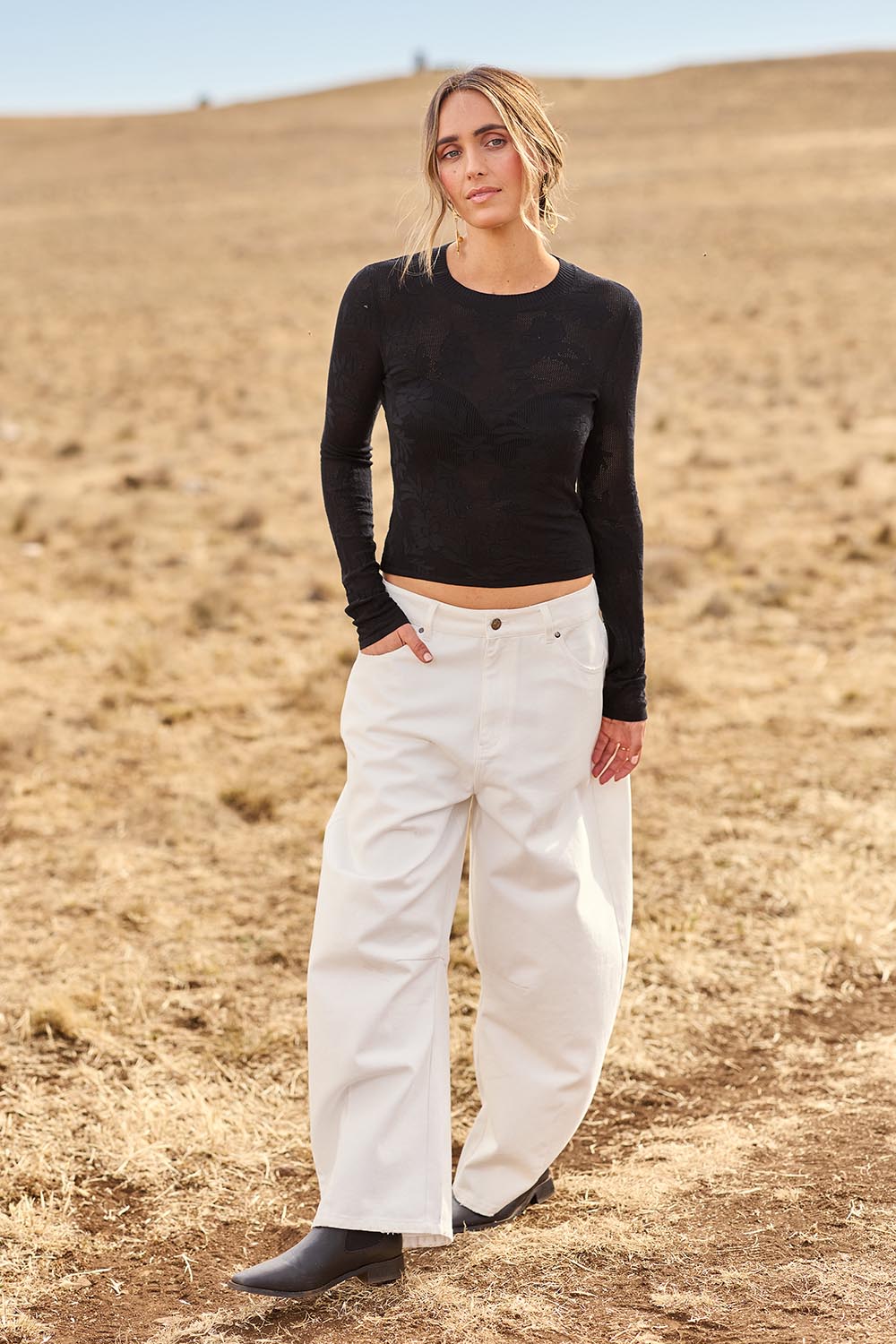 Model Tegan wearing size 10 of the Dusk To Dawn Cotton  Slouch Barrel Jeans in colour White (White), from the front, showing the whole outfit