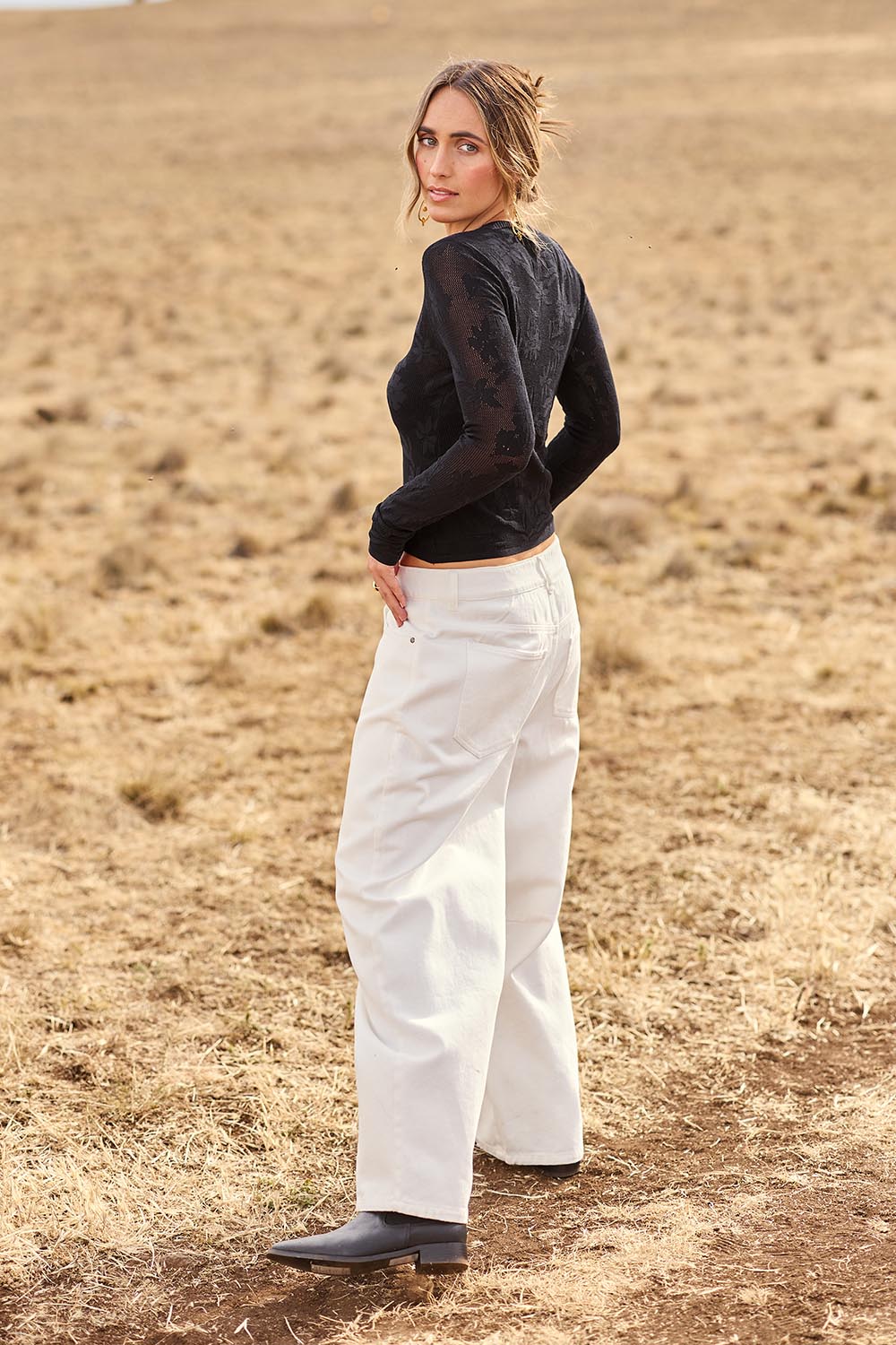 Model Tegan wearing size 10 of the Dusk To Dawn Cotton  Slouch Barrel Jeans in colour White (White), from the front, showing the whole outfit