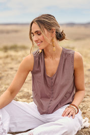 Model Tegan wearing size 10 of the Cute As A Button Cotton Tank in colour Raisin (Purple), from the front, cropped image