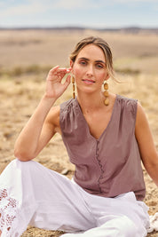 Model Tegan wearing size 12 of the Cute As A Button Cotton Tank in colour Raisin (Purple), from the front, cropped image