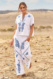 Model Tegan wearing size 10 of the Morning Sun Embroidered Cotton Pants in colour Whiteblue (Blue), from the front, showing the whole outfit