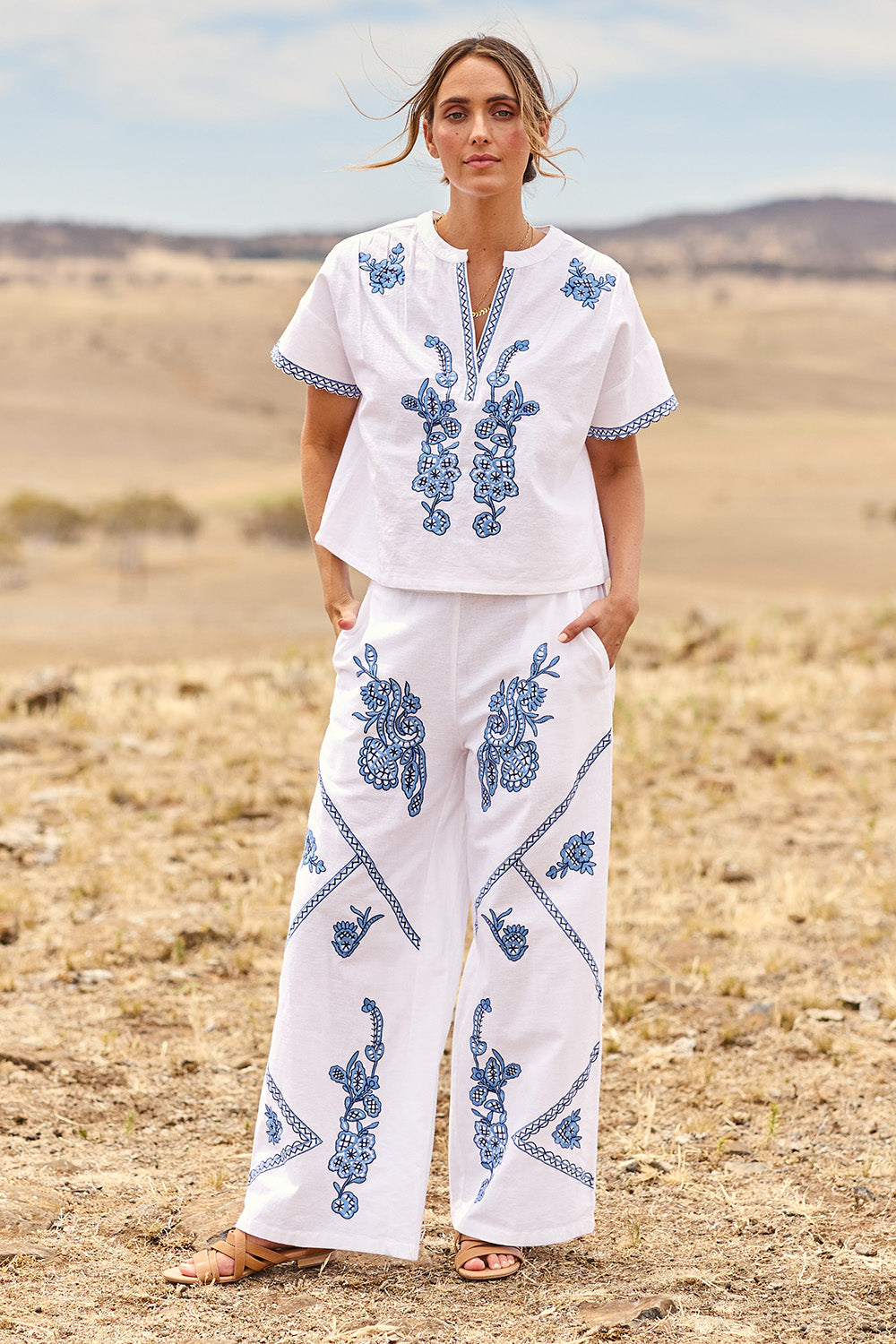 Model Tegan wearing size 10 of the Morning Sun Embroidered Cotton Pants in colour Whiteblue (Blue), from the front, showing the whole outfit