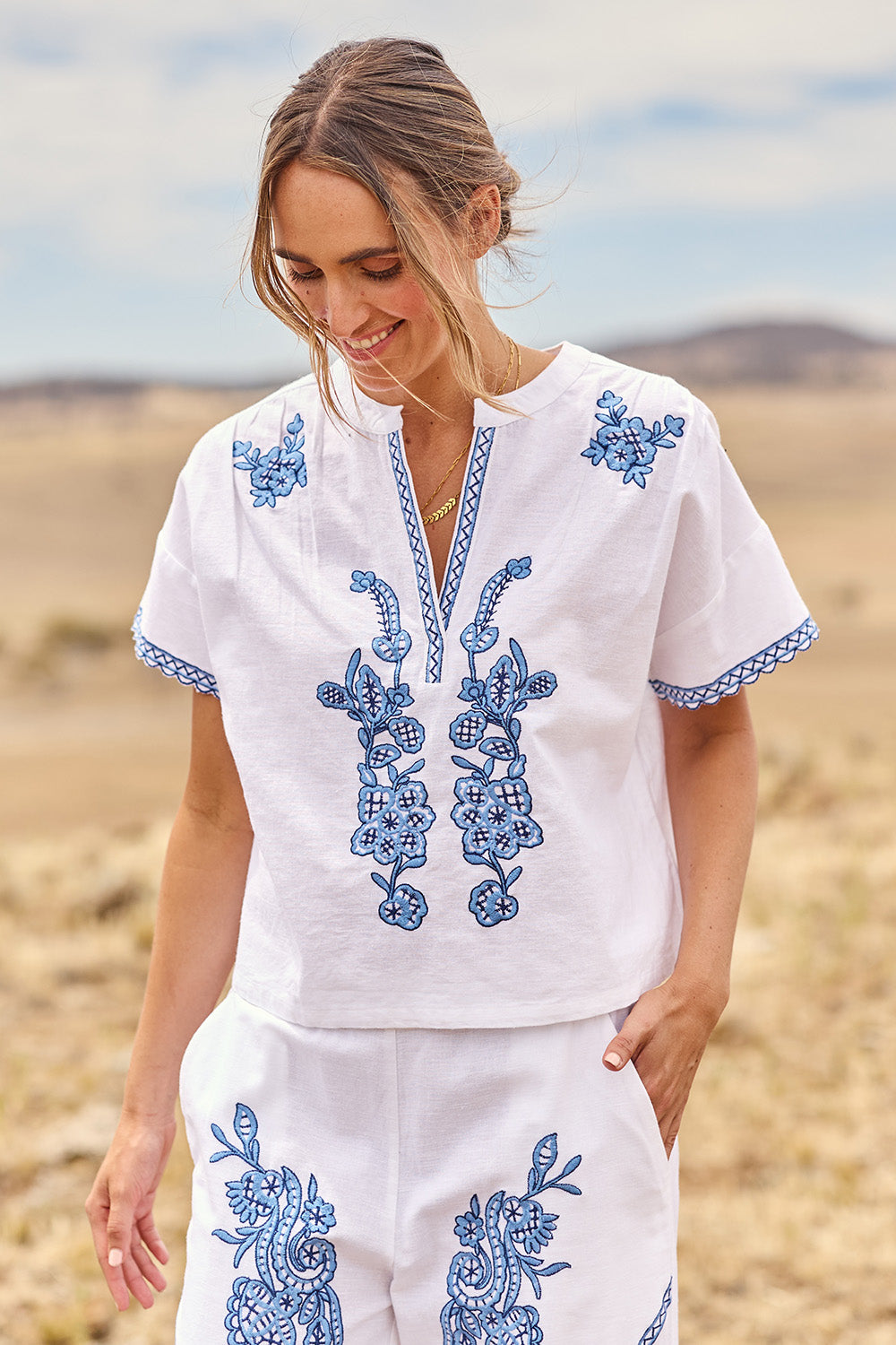 Model Tegan wearing size 10 of the Morning Sun Embroidered Cotton Top in colour Whiteblue (Blue), from the front, cropped image