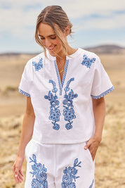 Model Tegan wearing size 10 of the Morning Sun Embroidered Cotton Top in colour Whiteblue (Blue), from the front, cropped image