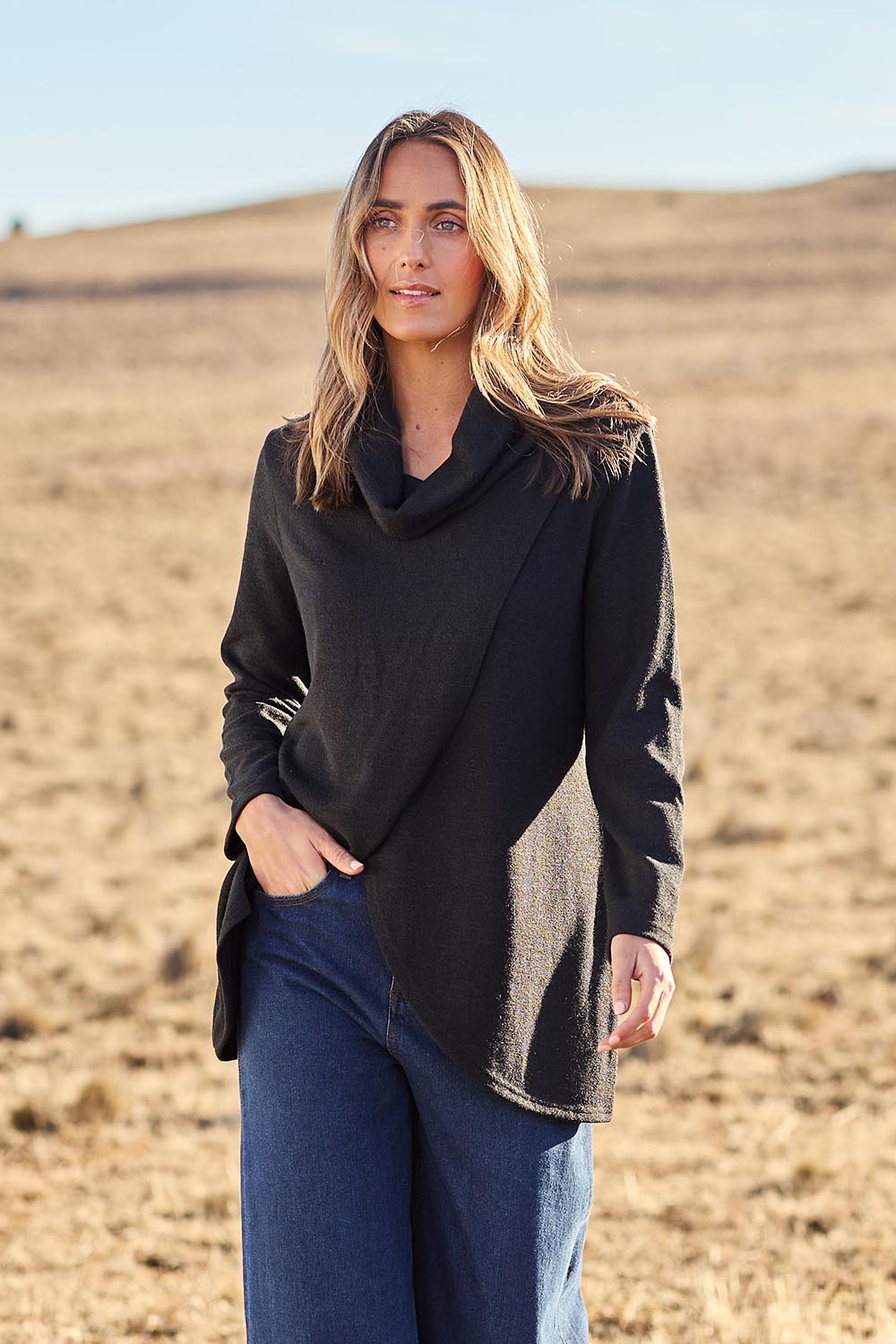 Model Tegan wearing size 10 of the Crossing The Plains Snuggle Jumper in colour Black (Black), from the front, showing the whole outfit