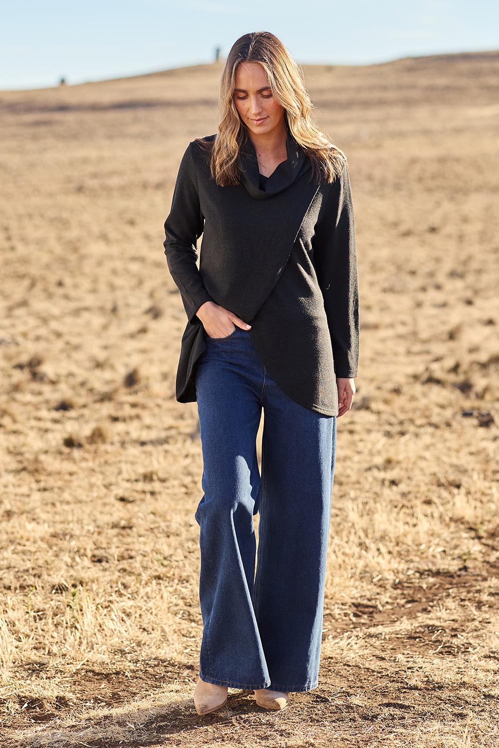 Model Tegan wearing size 10 of the Crossing The Plains Snuggle Jumper in colour Black (Black), from the front, showing the whole outfit