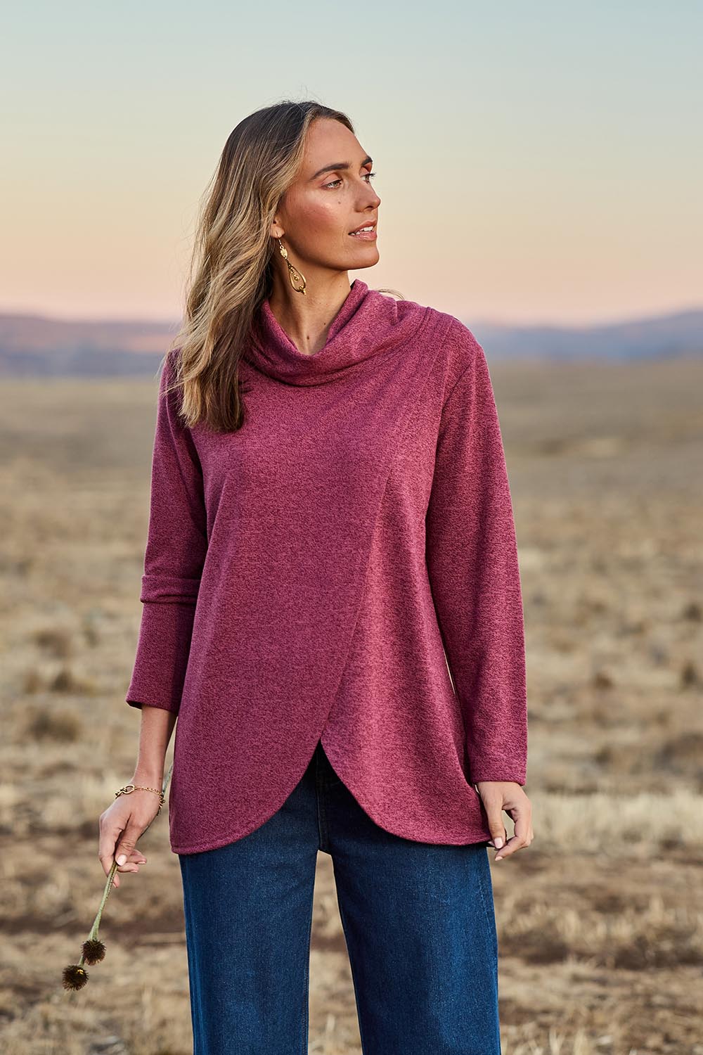 Model Tegan wearing size 10 of the Crossing The Plains Snuggle Jumper in colour Grape (Purple), from the front, showing the whole outfit