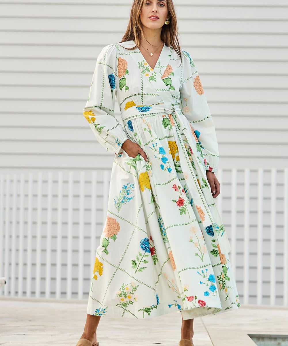 Model Tegand wearing size 10 of the Walking On Sunshine Cotton Maxi Wrap Dress – Flower in colour Flower, from the front