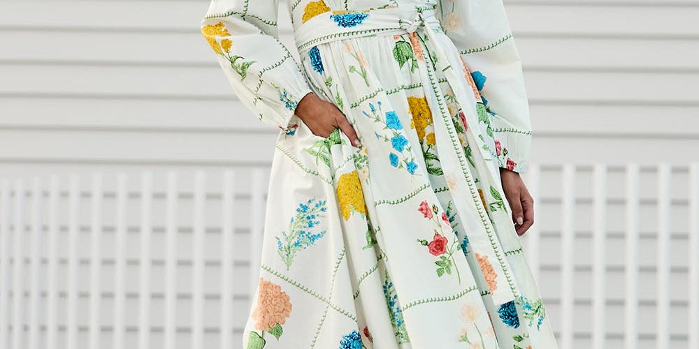 Model Tegand wearing size 10 of the Walking On Sunshine Cotton Maxi Wrap Dress – Flower in colour Flower, from the front