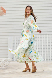 Model Tegand wearing size 10 of the Walking On Sunshine Cotton Maxi Wrap Dress – Flower in colour Flower, from the front