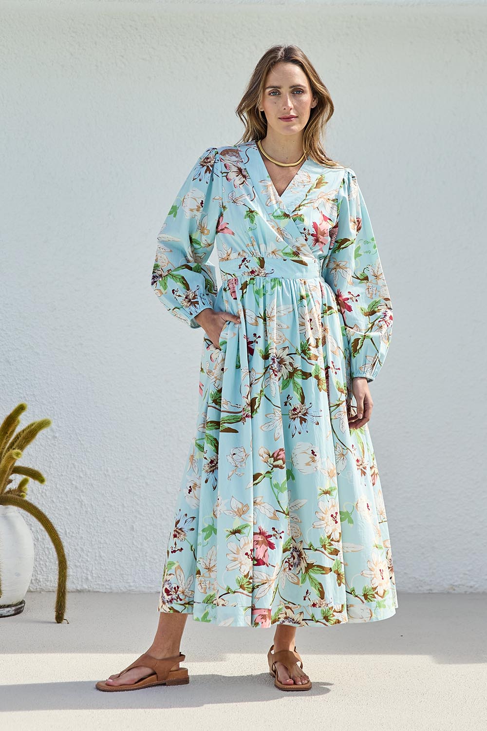 Model Tegand wearing size 10 of the Walking On Sunshine Cotton Maxi Wrap Dress – Skybloom in colour Skybloom, from the front