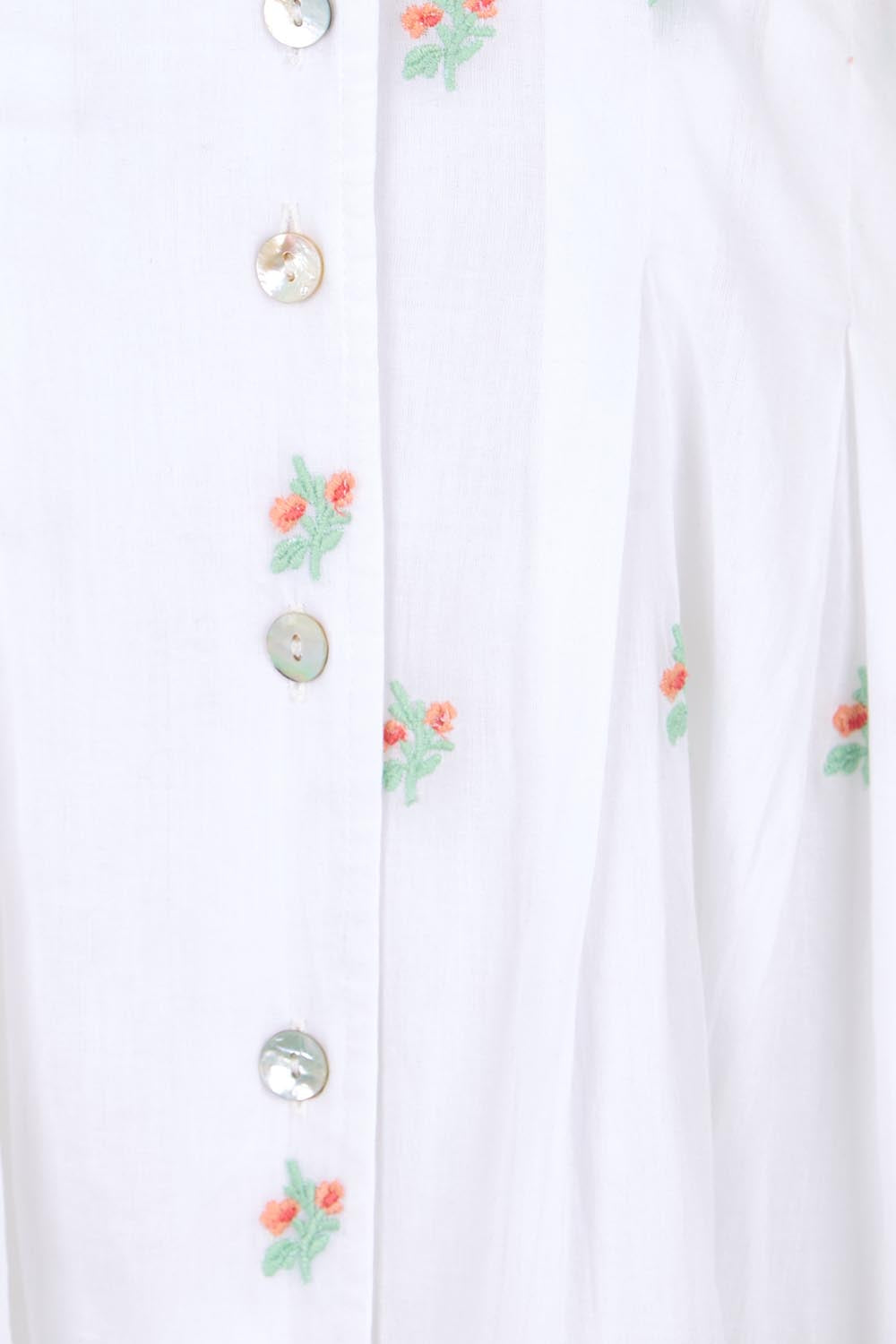 Product shot of the Flower Field Cotton Embroidered Dress – White in colour White, showing detail