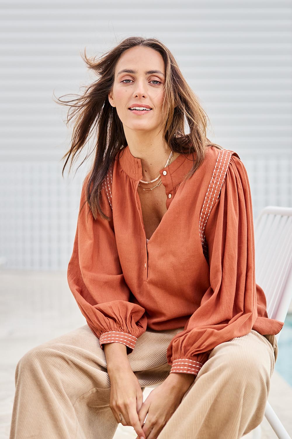 Model Tegand wearing size 10 of the Out And About Cotton Blouse – Rust in colour Rust, in a cropped view