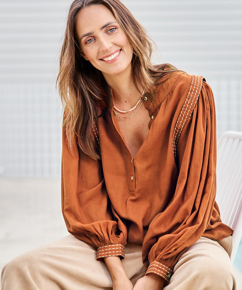 Model Tegand wearing size 10 of the Out And About Cotton Blouse – Rust in colour Rust, in a cropped view