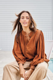 Model Tegand wearing size 10 of the Out And About Cotton Blouse – Rust in colour Rust, in a cropped view