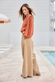 Model Tegand wearing size 10 of the Out And About Cotton Blouse – Rust in colour Rust, from the front