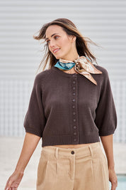 Model Tegand wearing size 10 of the Clear Skies Balloon Sleeve Cardi – Chocolate in colour Chocolate, from an angle
