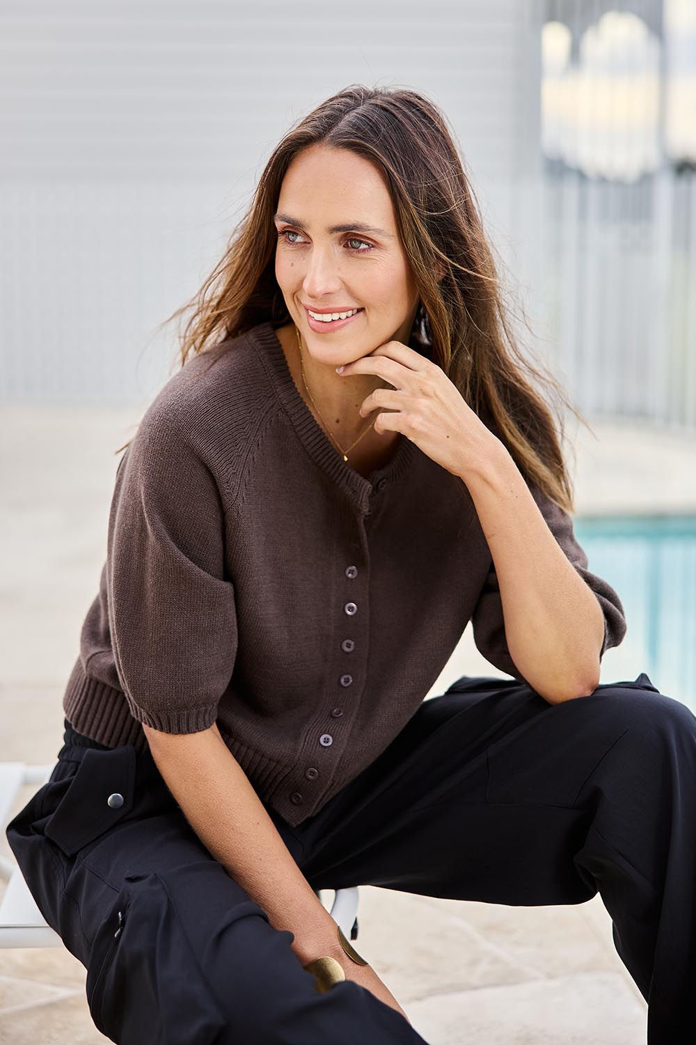 Model Tegand wearing size 10 of the Clear Skies Balloon Sleeve Cardi – Chocolate in colour Chocolate, from an angle