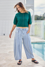 Model Tegand wearing size 10 of the Clear Skies Balloon Sleeve Cardi – Dreamgreen in colour Dreamgreen, from the front
