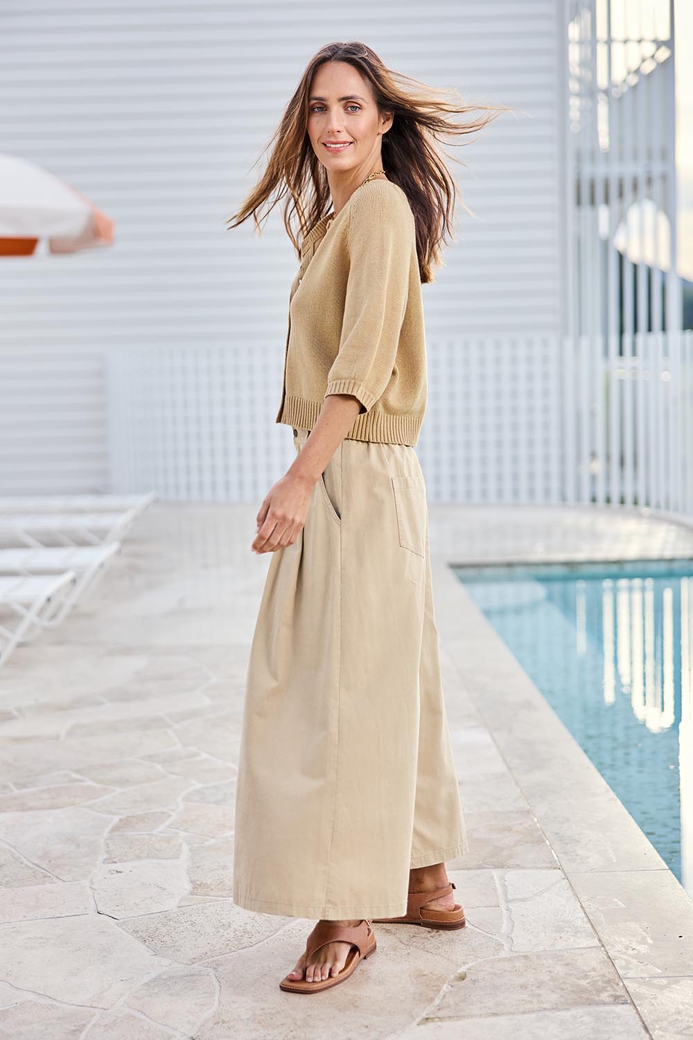 Model Tegand wearing size 10 of the Clear Skies Balloon Sleeve Cotton Blend Cardi – Sand in colour Sand, from the front