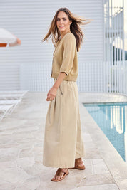 Model Tegand wearing size 10 of the Clear Skies Balloon Sleeve Cotton Blend Cardi – Sand in colour Sand, from the front