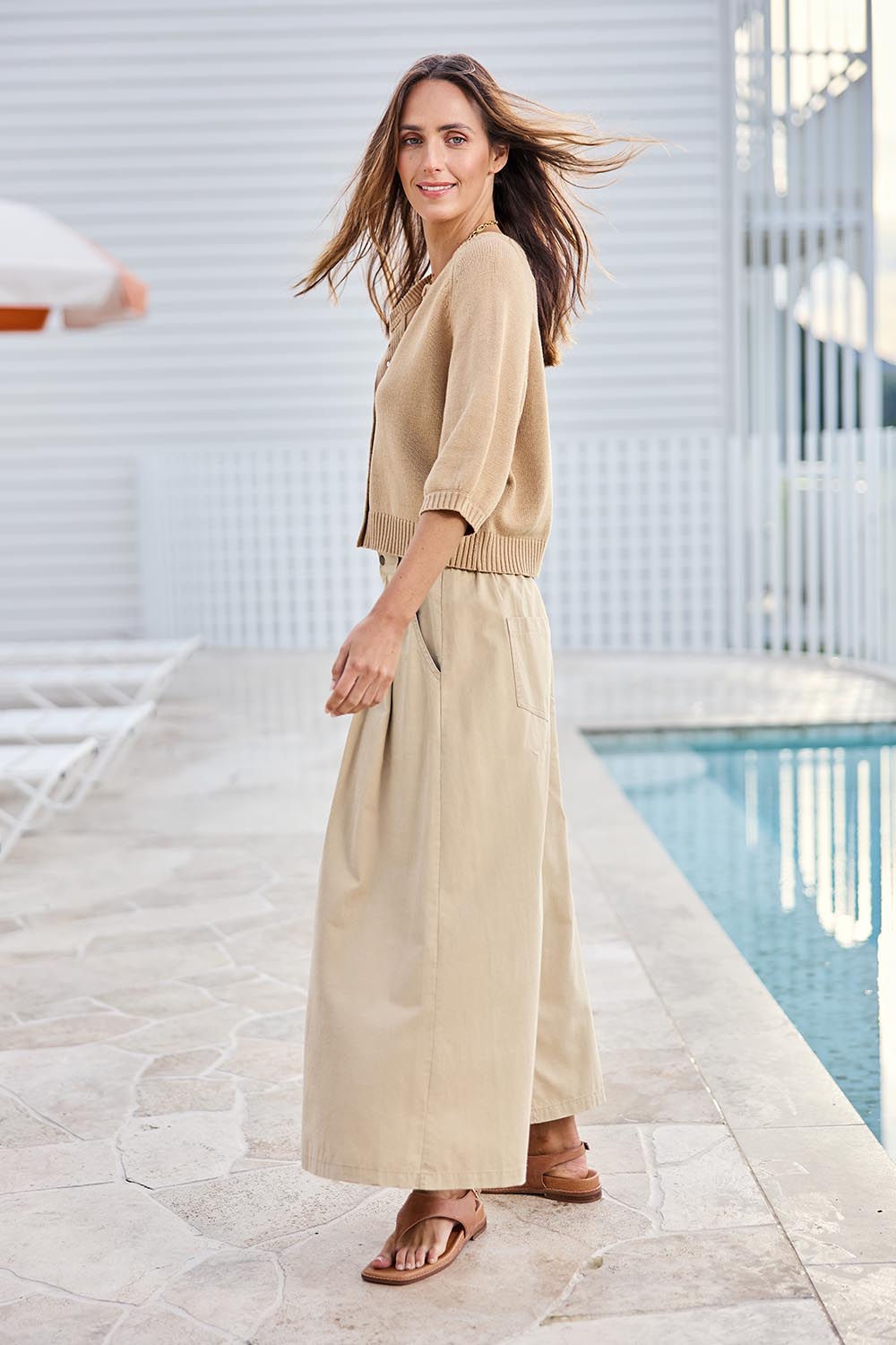 Model Tegand wearing size 10 of the Clear Skies Balloon Sleeve Cardi – Sand in colour Sand, from the front
