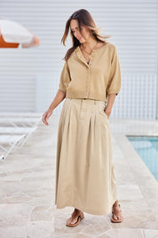 Model Tegand wearing size 10 of the Clear Skies Balloon Sleeve Cotton Blend Cardi – Sand in colour Sand, from the front