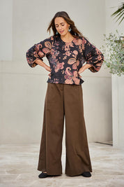 Model Tegand wearing size 10 of the Flowers For Me Balloon Sleeve Top – Blackfleur in colour Blackfleur, from the front