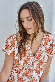 Model Tegand wearing size 10 of the Love You Bunches Maxi Dress – Blossom in colour Blossom, in a cropped view