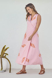 Model Tegand wearing size 10 of the Sweet Pea Embroidered Cotton Wrap Dress - Pinktangerine in colour Pinktangerine, from the front