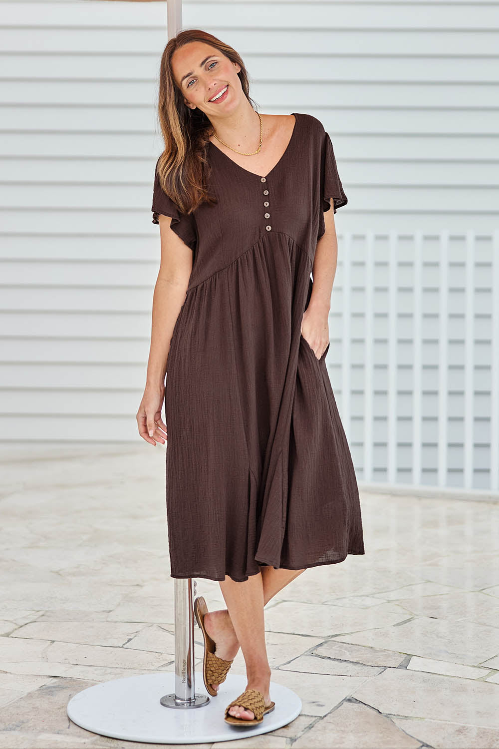 Model Tegand wearing size 10 of the Cute As A Button Cotton Midi Dress – Chocolate in colour Chocolate, from the front