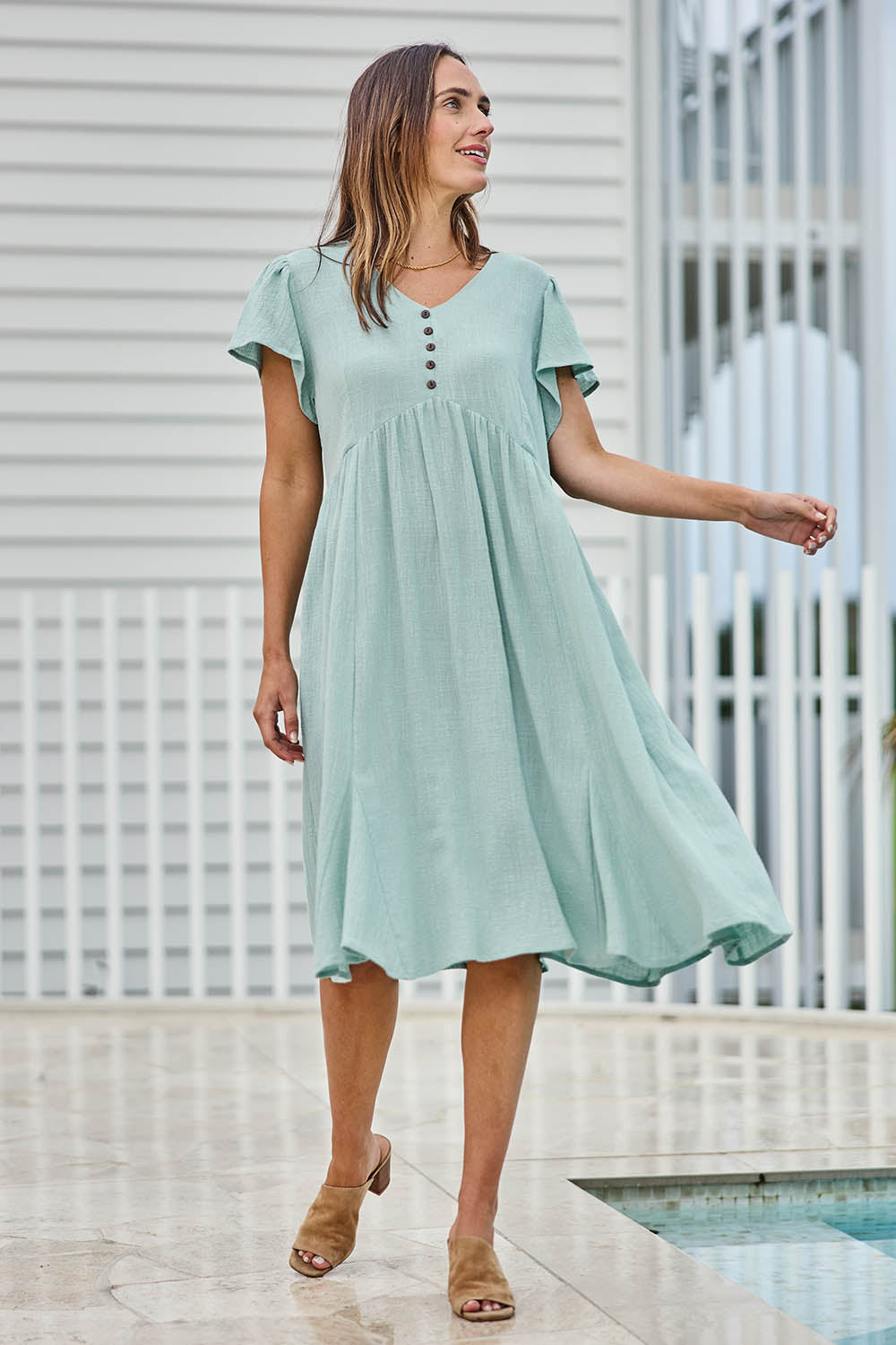 Model Tegand wearing size 10 of the Cute As A Button Cotton Midi Dress – Sage in colour Sage, from the front