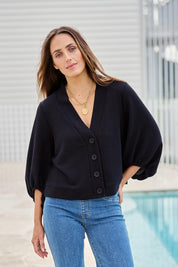 Model Tegand wearing size 10 of the Easy Day Balloon Sleeve Cropped Cardi – Black in colour Black, in a cropped view