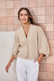 Model Tegand wearing size 10 of the Easy Day Balloon Sleeve Cropped Cardi – Pumice in colour Pumice, in a cropped view