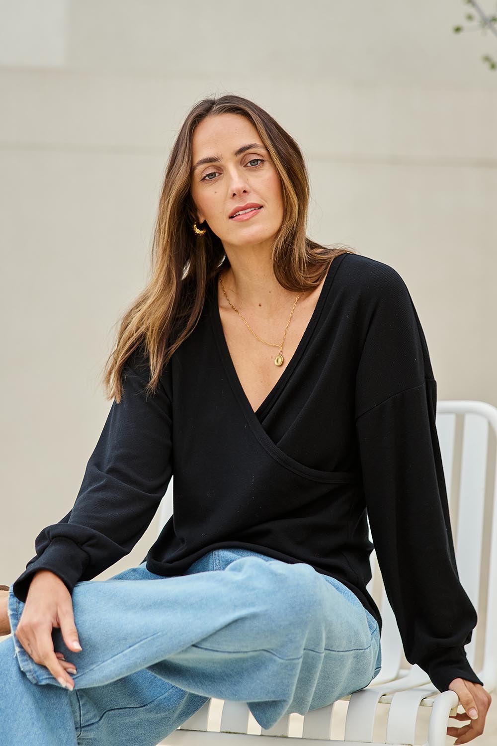 Model Tegand wearing size 10 of the Cross My Heart Sweater – Black in colour Black, in a cropped view