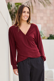 Model Tegand wearing size 10 of the Cross My Heart Sweater – Plum in colour Plum, in a cropped view