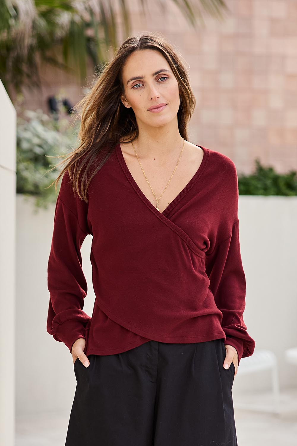 Model Tegand wearing size 10 of the Cross My Heart Sweater – Plum in colour Plum, in a cropped view
