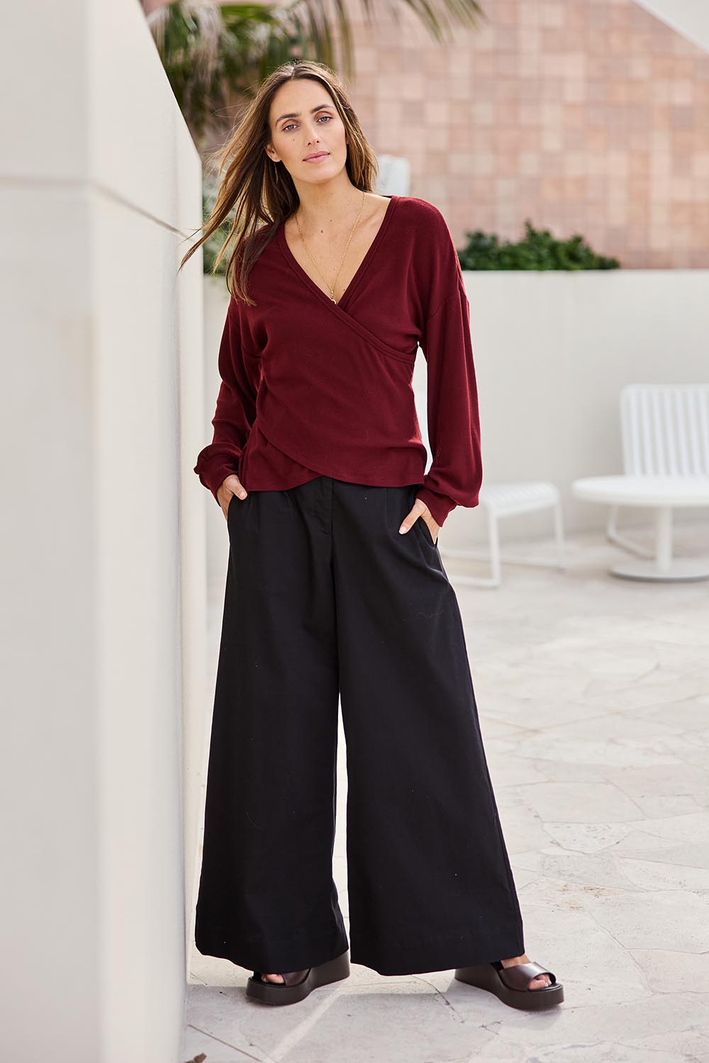 Model Tegand wearing size 10 of the Cross My Heart Sweater – Plum in colour Plum, from the front