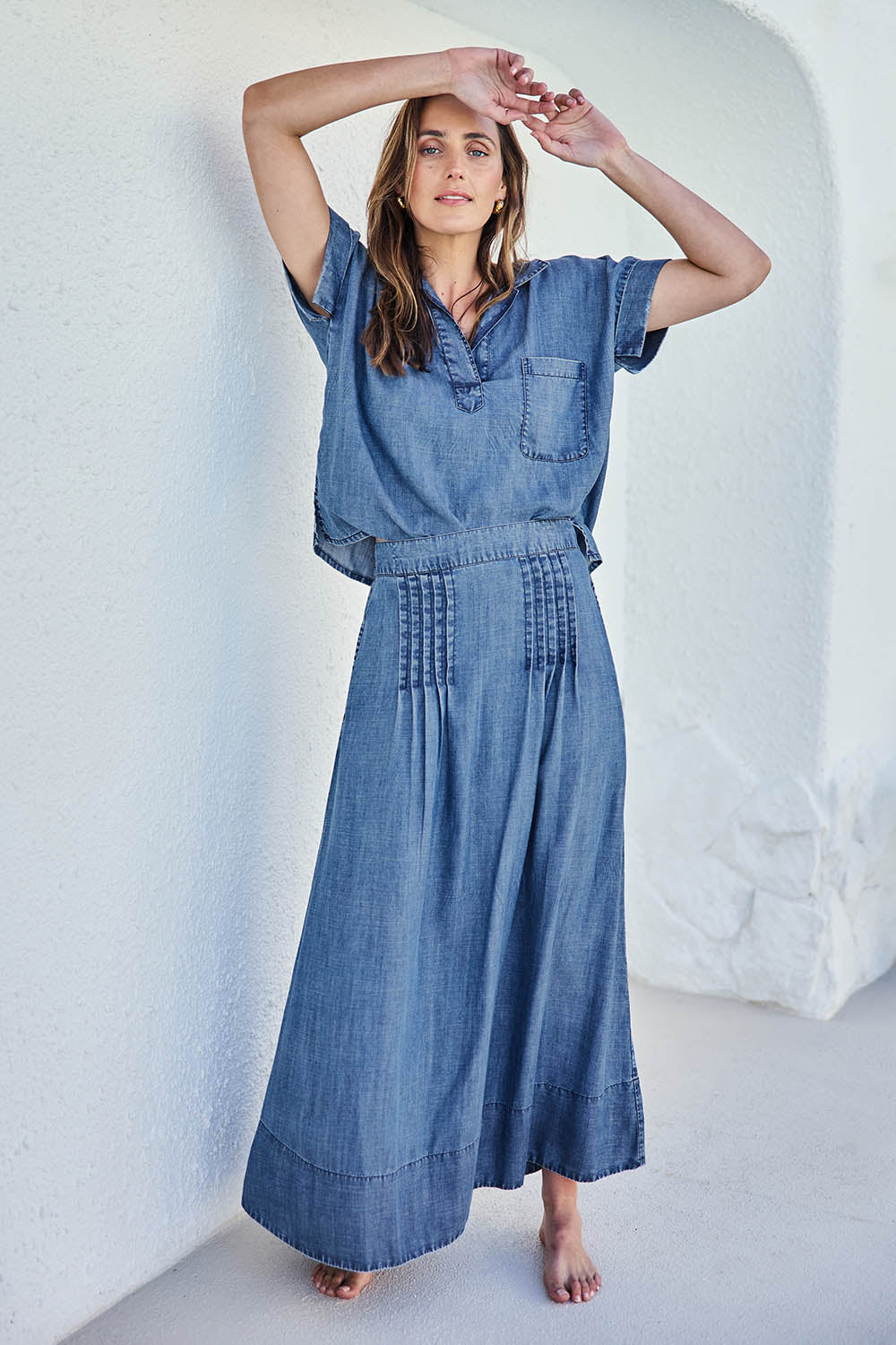 Model Tegand wearing size 10 of the Perfect Day Pleat Detail Lyocell Maxi Skirt – Denim in colour Denim, from the front