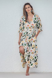 Model Tegand wearing size 10 of the Frill of Birds Cotton Wrap Dress - Birdfleur in colour Birdfleur, from the front