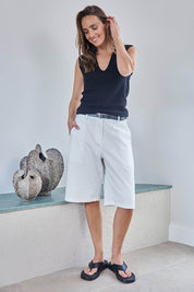 Model Tegand wearing size 10 of the Want You In My Life Long Line Shorts – White in colour White, from the front
