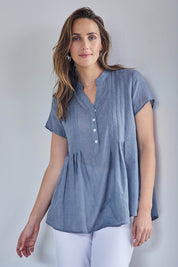 Model Tegand wearing size 10 of the Pleated Delight Cotton Blouse – Denim in colour Denim, in a cropped view