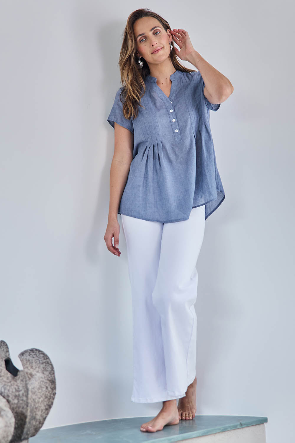 Model Tegand wearing size 10 of the Pleated Delight Cotton Blouse – Denim in colour Denim, from the front