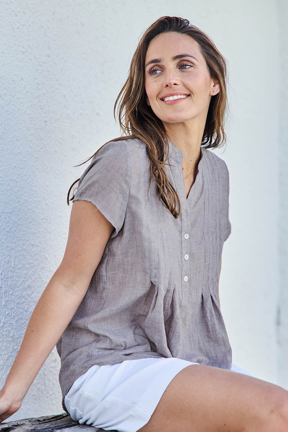 Model Tegand wearing size 10 of the Pleated Delight Cotton Blouse – Latte in colour Latte, from an angle