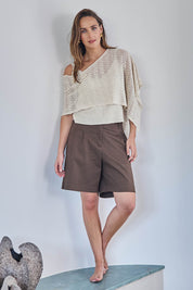 Model Tegand wearing size 10 of the Golden Hour Knit Top And Poncho Set - Natural in colour Natural, from the front